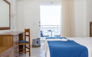 a bedroom with a bed and a desk and a window at Meridien Beach Hotel in Argassi +23 photos