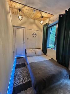 a small bedroom with two beds in a trailer at Quattro Malyovitsa- Мальовица in Govedartsi +75 photos