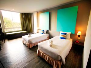 Postel nebo postele na pokoji v ubytování Thepnakorn Hotel + 61 fotografií