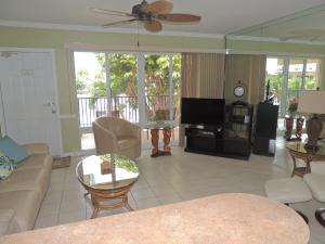 a living room with a couch and a tv at Aqua Mar Condos in Pompano Beach