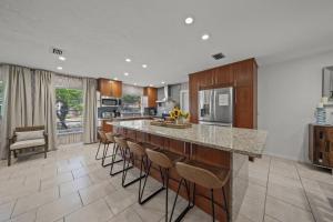 a kitchen with a bar with stools and a counter top at Temporary Sanity in Sarasota