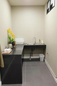 a bathroom with a sink and a toilet at M-one Residence in Ban Kohong