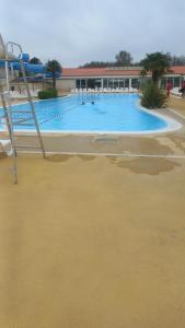a large swimming pool in the middle of a beach at Mobilhome 602 in Les Mathes