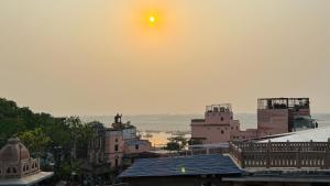 a view of a city with the sun in the sky at Spiritual Homestay in Varanasi