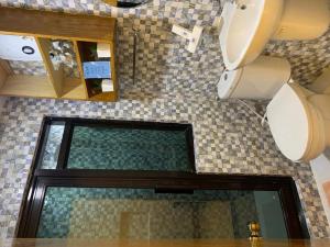 a bathroom with a toilet and a sink and a mirror at Alona Mariners Resort in Panglao +46 photos