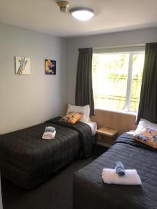 Ένα ή περισσότερα κρεβάτια σε δωμάτιο στο Christchurch Motel