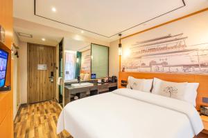 a bedroom with a large white bed and a sink at YOYO PINKE Hotel in Beijing