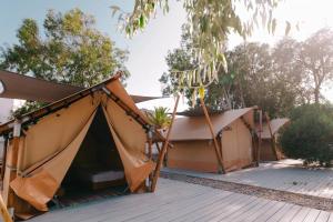 a tent on top of a wooden deck at FarOut - BeachResort & Camping in Mylopotas