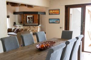 a dining room with a wooden table and chairs at Afrikaya Bush Lodge in Hoedspruit