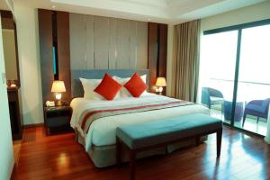 a bedroom with a bed with orange pillows and a balcony at Summer Hotel in Dong Quan +35 photos