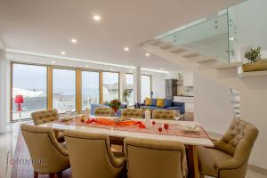 a living room with a large table and chairs at Villa Benić in Crikvenica