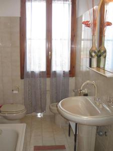 a bathroom with a sink and a toilet and a tub at Appartamento Vacanze in Stintino