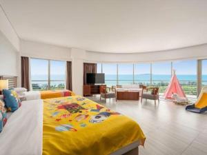 a bedroom with a large bed and a living room at Grand Soluxe Hotel and Resort Sanya in Sanya