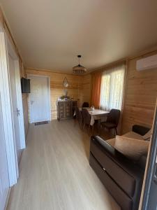 una sala de estar con un sofá y una mesa en კოტეჯი 109, en Itʼkhvisi