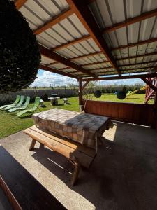a patio with a bed under a pergola at Sunny Faház in Poroszló