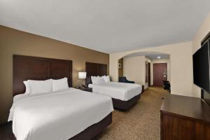 a hotel room with two beds and a flat screen tv at Comfort Inn & Suites Atoka in Atoka +127 photos
