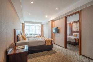 Postel nebo postele na pokoji v ubytování Zhaoqing Shanshui Fashion Hotel Duanzhou Road Branch + 141 fotografií