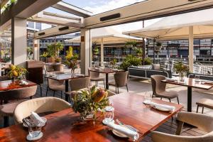 an outdoor restaurant with tables and chairs and tablesktop at Pier One Sydney Harbour, Autograph Collection in Sydney