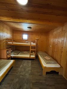 a room with two bunk beds in a cabin at Sunny Faház in Poroszló