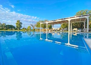 a swimming pool with a pavilion on top of it at Masseria La Millenaria in San Foca