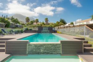 a swimming pool in the backyard of a house at Stellenbosch Luxury Apartments in Stellenbosch