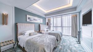 a hotel room with two beds and a television at Xian Jue Vu Hotel in Xi'an +287 photos