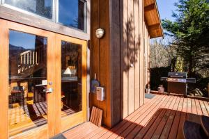 a wooden front door of a house with a deck at Mt Baker Rim Cabin #44 - Hot Tub- Pets Ok - Wifi in Glacier