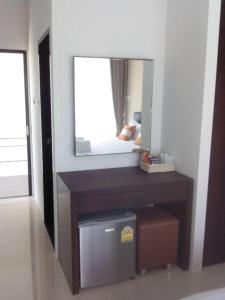 a bathroom with a mirror and a table with a drawer at Haak Boutique Hotel in Chiang Mai