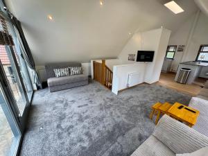a living room with a couch and a table at Severn View Barn -5 min from M5, J14 in Thornbury