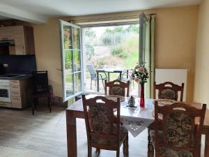 a kitchen and dining room with a table and chairs at Ferienhof NaturZeit in Horsmar +8 photos