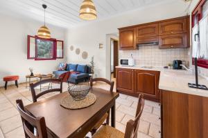 a kitchen and living room with a table and chairs at A & G House Lefkada in Lefkada
