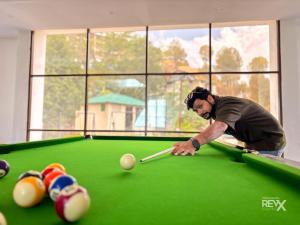 a man is playing pool on a pool table at Winterline Gold Resort in Lansdowne