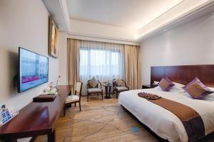 a hotel room with a large bed and a television at Huading International Hotel in Hangzhou +185 photos