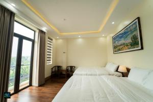 a bedroom with two beds and a large window at Cao Bang Eco Bistro & Stay in Cao Bằng +34 photos