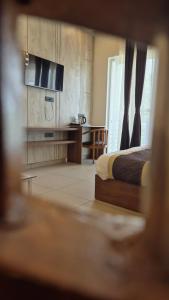 a bedroom with a bed and a desk in a room at The Corbett Green Woods in Rāmnagar