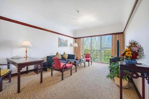a living room with a couch and chairs and a table at Wonderport International Hotel in Lijiang
