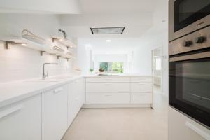 アグア・アマルガにあるCasita Agua Marinaのシンクとコンロのある白いキッチン