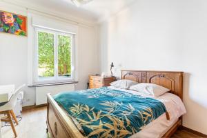a bedroom with a bed and a desk and a window at Spacious 3 bedrooms apartement 135 m & privative parking in Lille