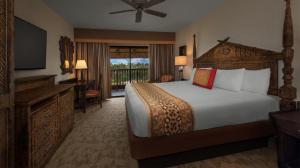a bedroom with a bed and a desk and a television at Disney's Animal Kingdom Villas - Jambo House in Orlando +44 photos