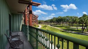 a balcony with two chairs and a view of a park at Disney's Animal Kingdom Villas - Jambo House in Orlando