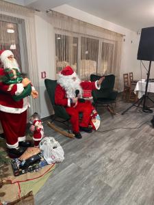 a group of santa clauses in a living room at Vila Orizont Straja in Straja
