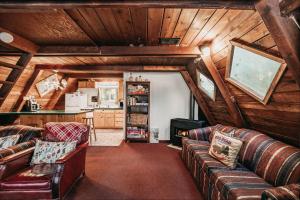 ein Wohnzimmer mit Ledersofas und eine Küche in der Unterkunft Snowline Cabin #54 - Hot Tub - Pets Ok in Glacier