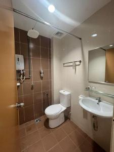 a bathroom with a toilet and a sink at Hotel Zamburger Bangsar (Previously Koptown Hotel Bangsar) in Kuala Lumpur
