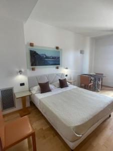 a bedroom with a large bed and a table at garibaldi citta' in Trapani