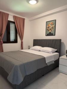 a bedroom with a large bed in a room at Midpoint Sea and Sun in Kotor