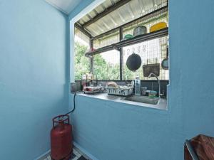a kitchen with a sink and a window at OYO 90708 D'kuala Waterfront Chalet & Boat Charters in Kampong Aman