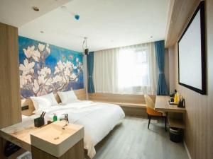 Un ou plusieurs lits dans un hébergement de l'établissement Magnotel Business Yixing Passenger Station Tuanjiu Scenic Area 109 autres photos