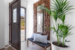 a potted plant in a hallway with a mirror at Waves - Seaside Escape in Chania Town +28 photos