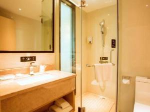 a bathroom with a sink and a shower at City Comfort Inn Hezhou Avenue in Hezhou +86 photos