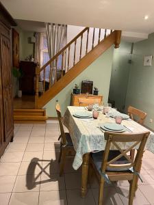 a dining room with a table with chairs and a staircase at Casa Brugensis holiday home in historic center of Bruges in Bruges +12 photos
